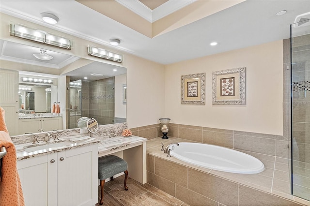 bathroom with separate shower and tub, vanity, and ornamental molding