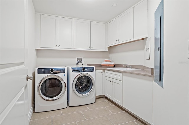 washroom featuring cabinets, independent washer and dryer, and sink