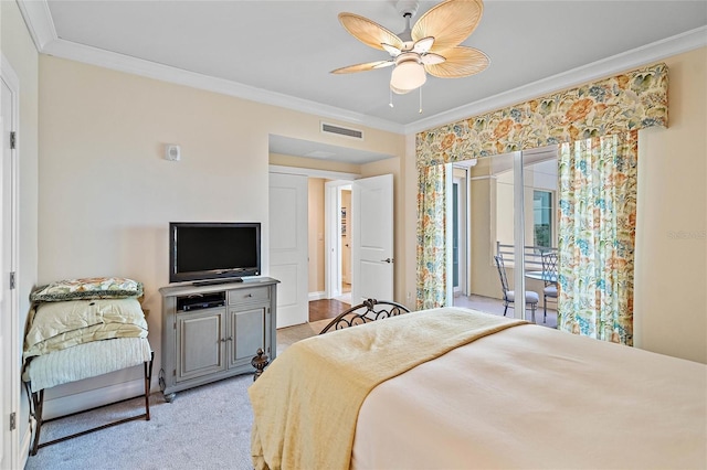 carpeted bedroom with ceiling fan and ornamental molding