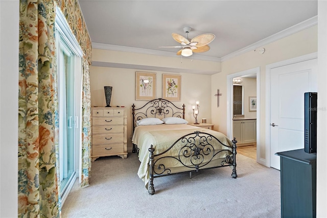 bedroom featuring ensuite bath, ceiling fan, light carpet, and ornamental molding