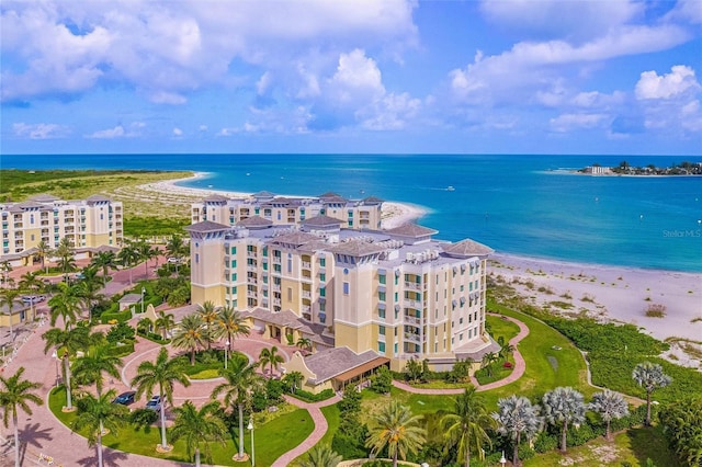 aerial view with a water view and a beach view