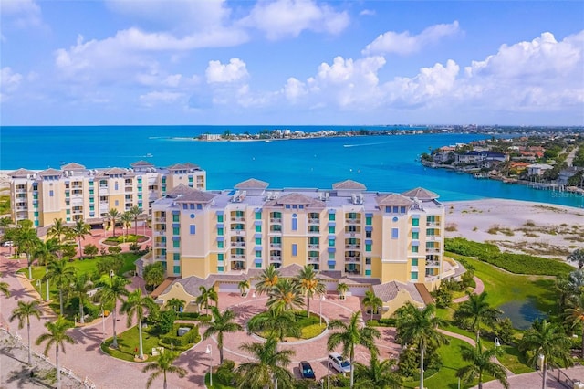 aerial view with a water view and a beach view