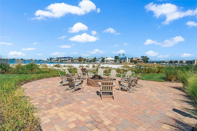 view of patio featuring a water view and an outdoor fire pit