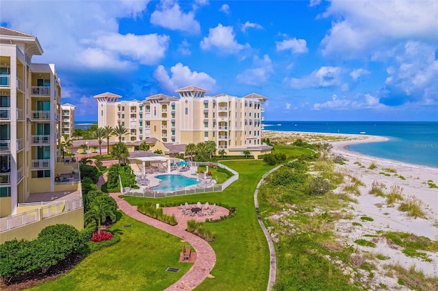 exterior space featuring a water view and a view of the beach