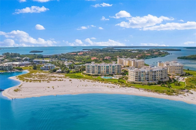 birds eye view of property with a water view and a view of the beach