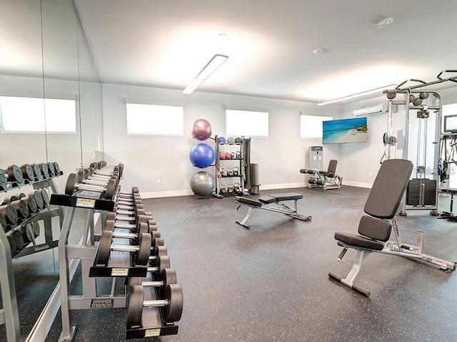 workout area featuring a wall mounted air conditioner