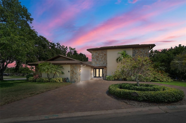 view of front of property with a yard and a garage