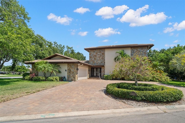 view of front of home with a front lawn and a garage