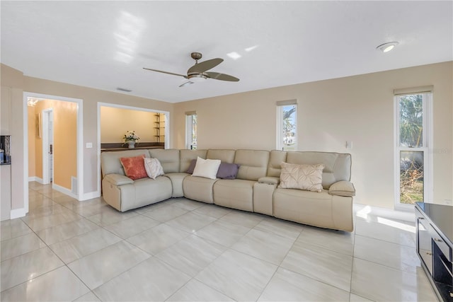 living room with ceiling fan and light tile patterned floors