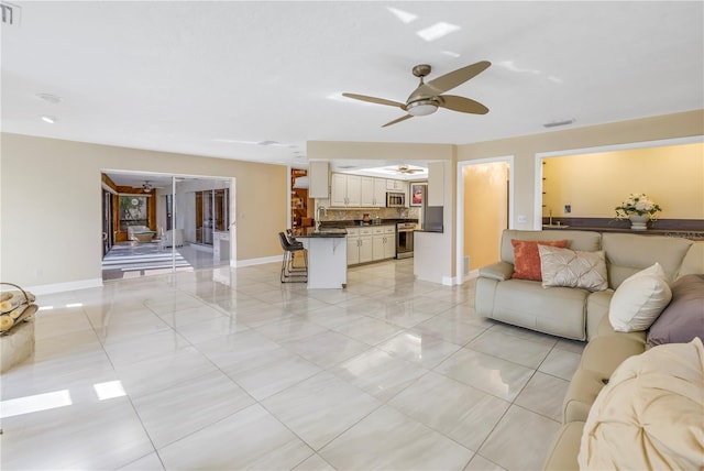 living room featuring ceiling fan and sink