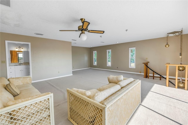 living room featuring carpet floors and ceiling fan