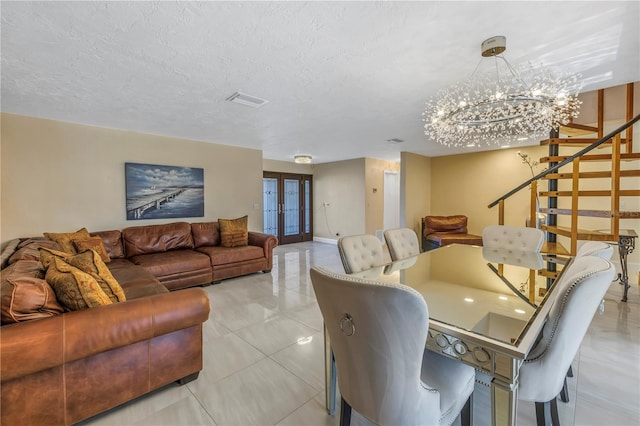 dining room with french doors and a textured ceiling