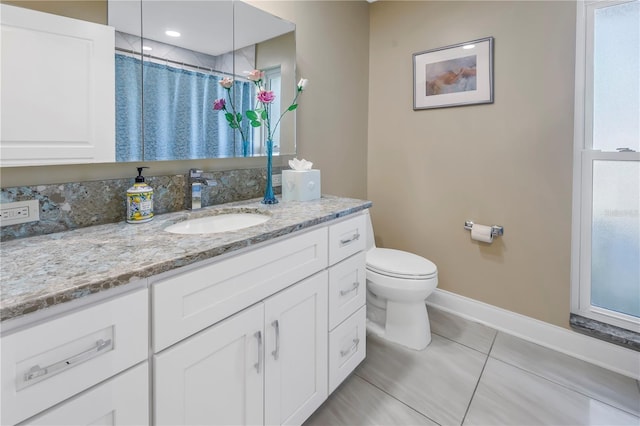 bathroom with toilet, vanity, a shower with shower curtain, and tile patterned flooring