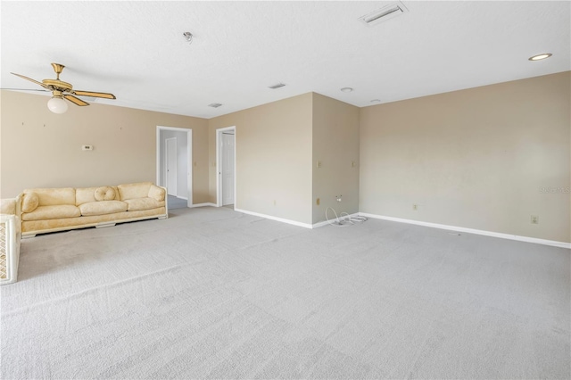 unfurnished living room featuring ceiling fan and carpet flooring