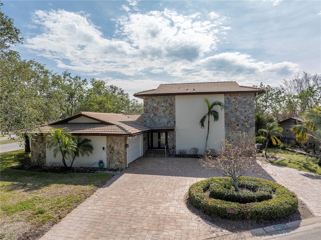 mediterranean / spanish-style home featuring a garage