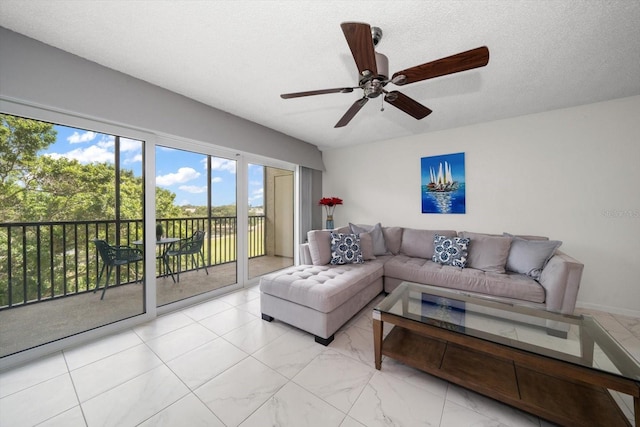 living room featuring a textured ceiling and ceiling fan