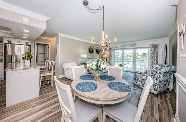 dining space featuring crown molding and a chandelier