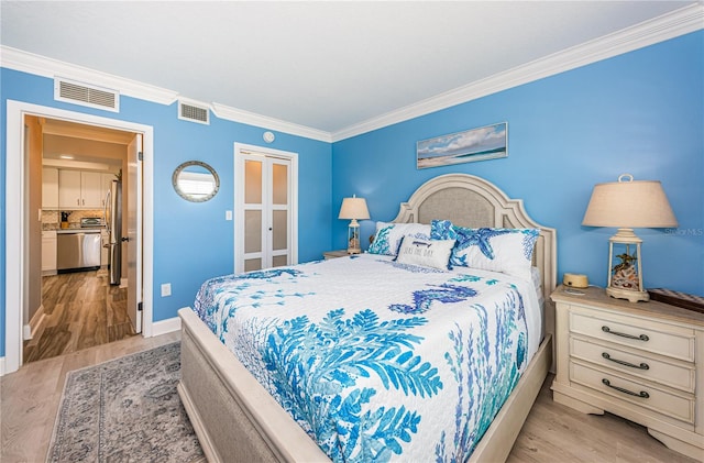 bedroom featuring stainless steel fridge, light hardwood / wood-style floors, and ornamental molding