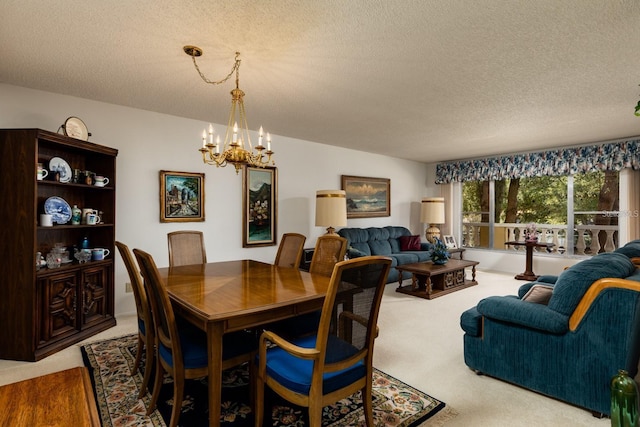 dining area featuring a textured ceiling, a notable chandelier, and carpet floors