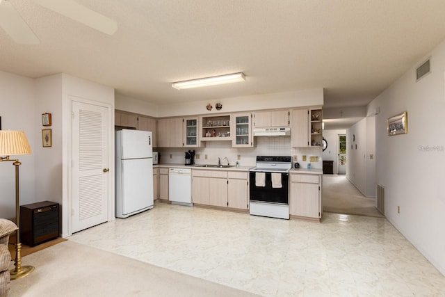 kitchen with sink, white appliances, and tasteful backsplash