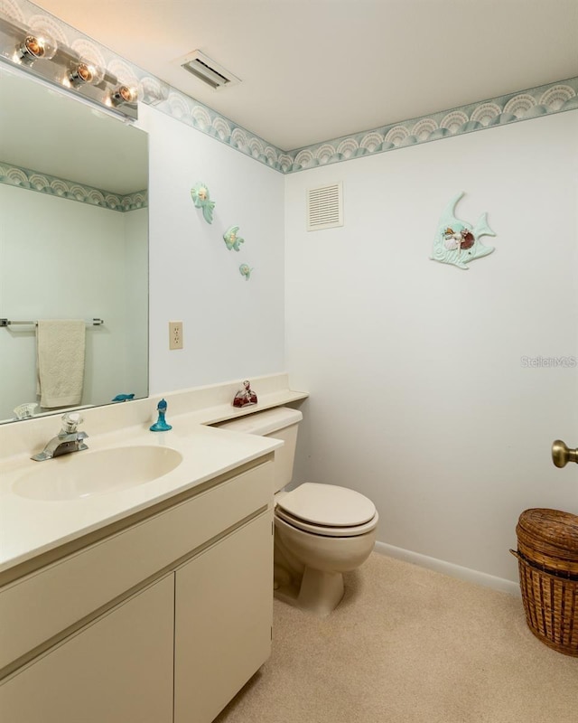 bathroom featuring toilet and vanity