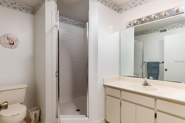 bathroom with vanity, toilet, and walk in shower