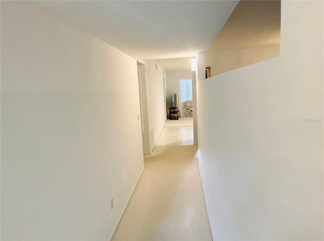 hallway with a textured ceiling