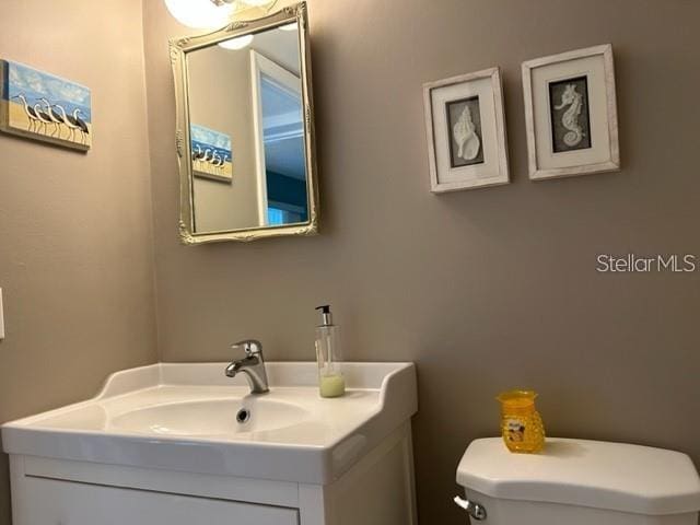 bathroom featuring vanity and toilet