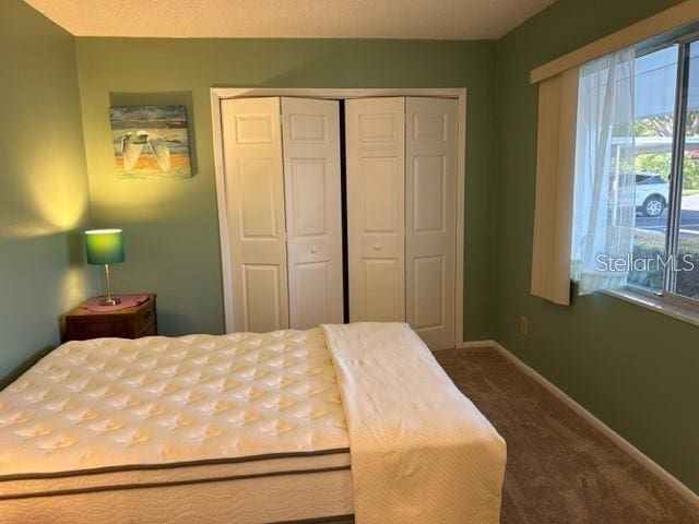 carpeted bedroom featuring a closet