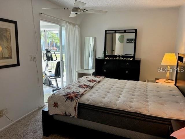 bedroom featuring access to exterior, ceiling fan, carpet, and a textured ceiling