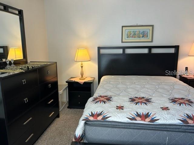 bedroom featuring light colored carpet