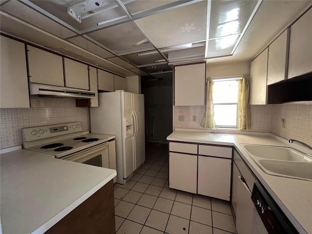 kitchen with white appliances, tasteful backsplash, white cabinetry, and sink