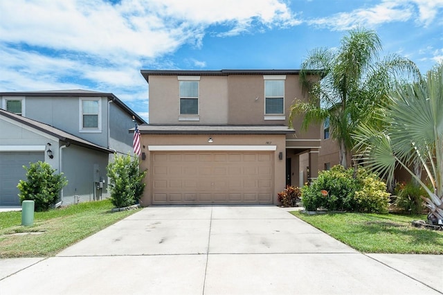 view of property featuring a front yard and a garage