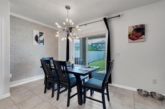 dining room featuring light tile patterned flooring, brick wall, and a chandelier