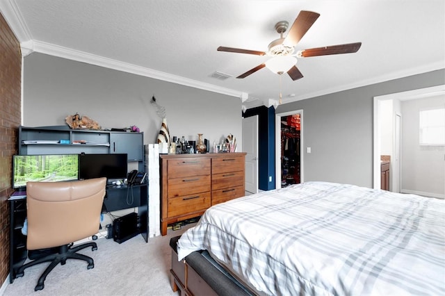 bedroom with crown molding, ceiling fan, connected bathroom, carpet floors, and a closet