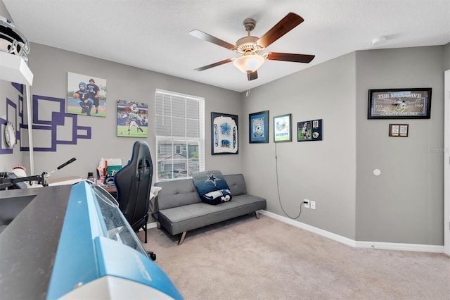 office featuring ceiling fan, light colored carpet, and a textured ceiling