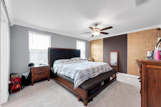 carpeted bedroom featuring a textured ceiling, ceiling fan, crown molding, and brick wall