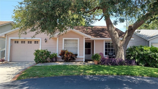 view of front of house featuring a front lawn and a garage