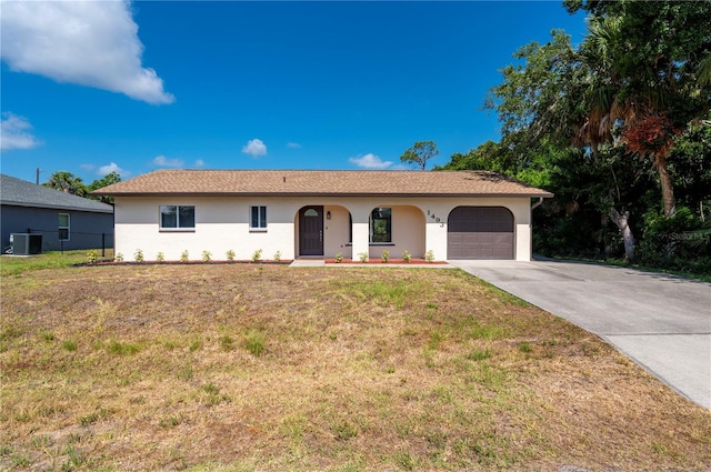 ranch-style house featuring a garage, central AC, and a front yard