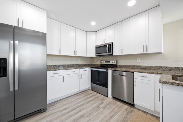 kitchen with stainless steel appliances and white cabinetry