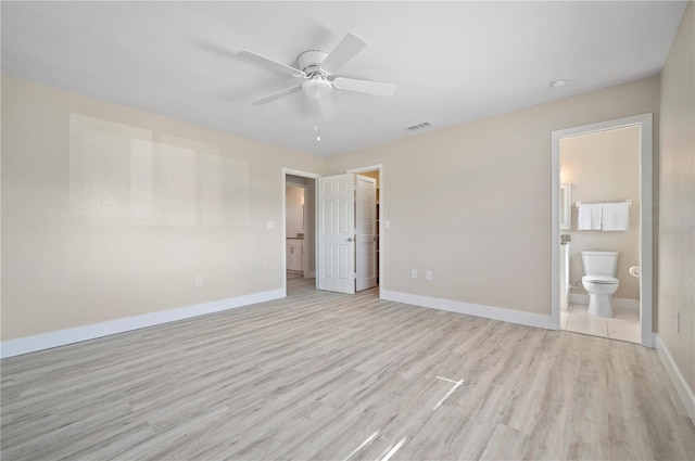 unfurnished bedroom with ensuite bath, ceiling fan, and light wood-type flooring