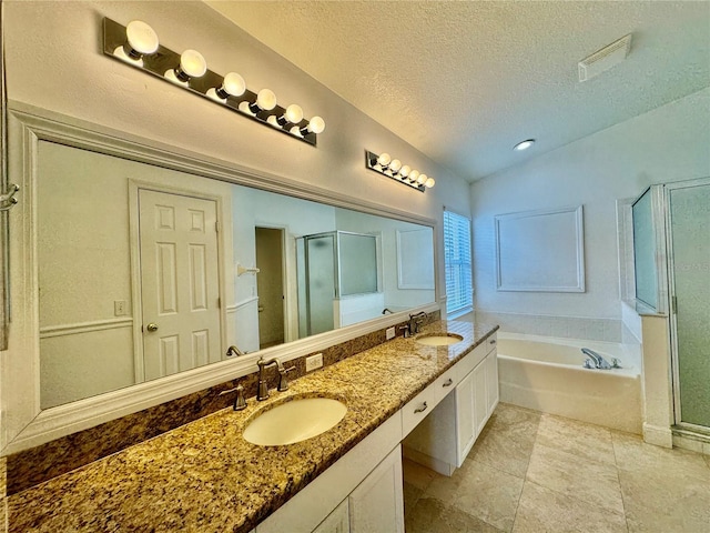 bathroom with vanity, a textured ceiling, separate shower and tub, and vaulted ceiling