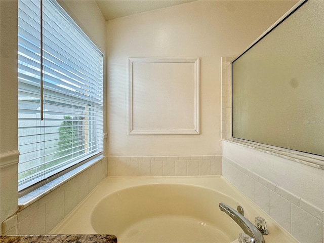 bathroom with a tub to relax in