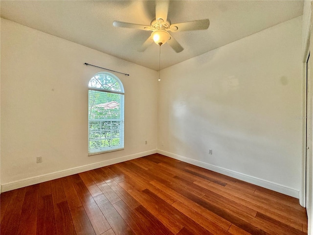 spare room featuring hardwood / wood-style floors and ceiling fan