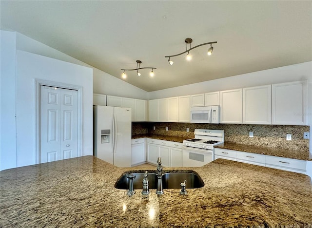 kitchen with lofted ceiling, backsplash, sink, and white appliances