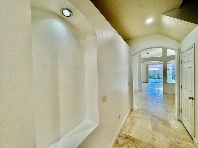 hallway featuring lofted ceiling