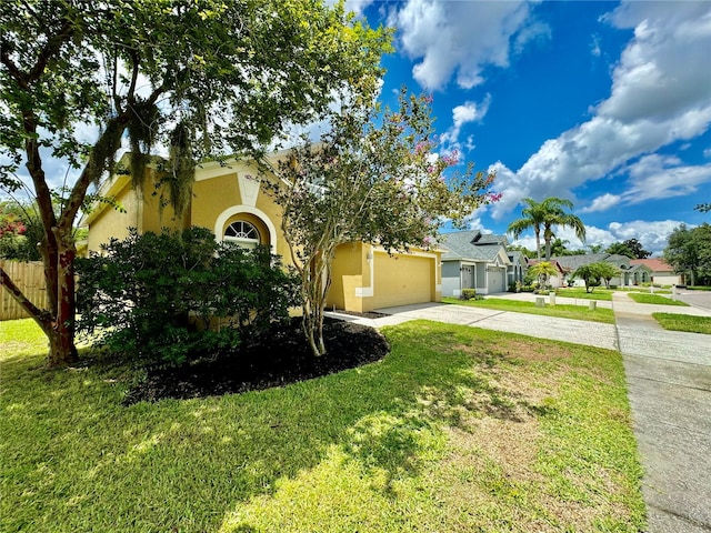 view of front of home with a garage and a front yard