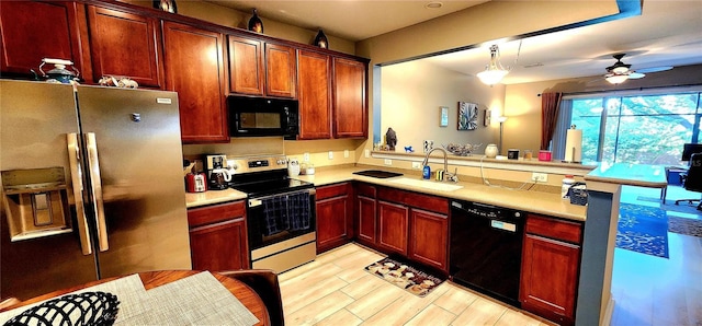 kitchen with pendant lighting, sink, black appliances, and ceiling fan