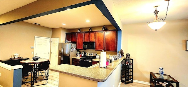 kitchen with a kitchen bar, light wood-type flooring, appliances with stainless steel finishes, kitchen peninsula, and pendant lighting