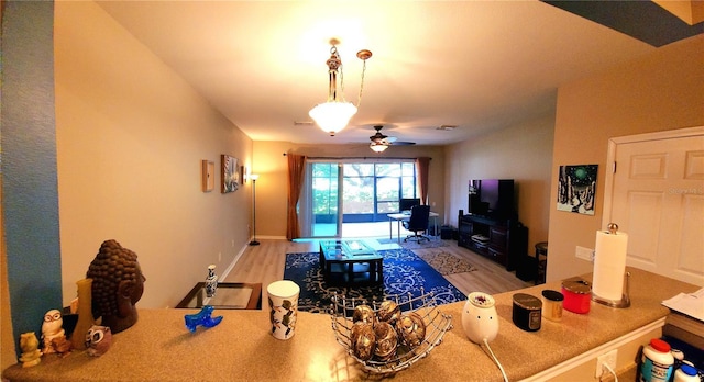 living room featuring ceiling fan and light hardwood / wood-style flooring